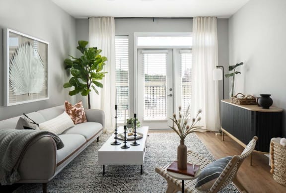 Living room with balcony door at Alta Davis luxury apartments in Durham, NC