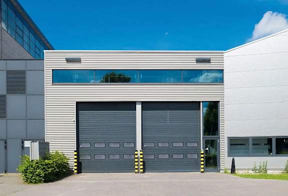 a white building with two garage doors