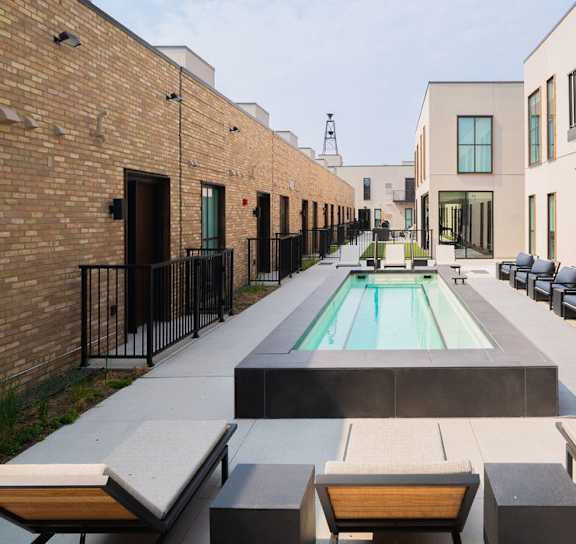 a rendering of a pool in front of a building at One West Drive Apartments, Excelsior, Minnesota
