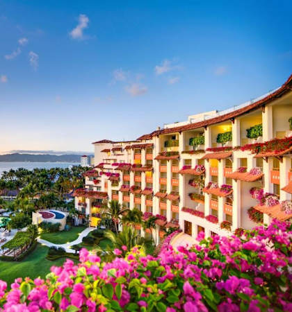 A beautiful resort with a pool and palm trees.