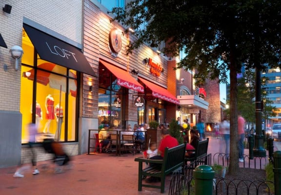 a group of people sitting outside of a restaurant