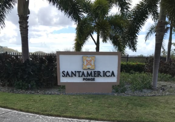 a sign for santamarica power in front of palm trees