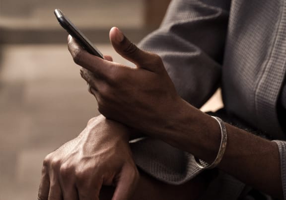 a close up of a man holding a cell phone in his hands