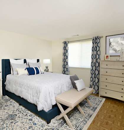 a bedroom with a bed and a rug
