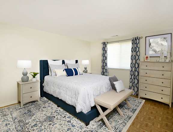 a bedroom with a bed and a rug