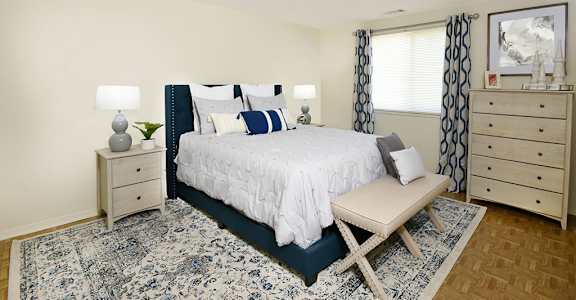 a bedroom with a bed and a rug