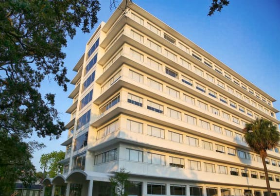 a tall building with cars parked in front of it at The Mobile Lofts, Alabama, 36604