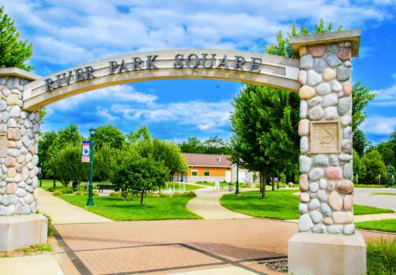 A stone archway with the words "River Park Square" on it.