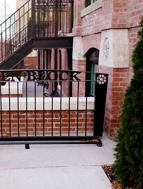 A bicycle is parked on a railing outside a building.