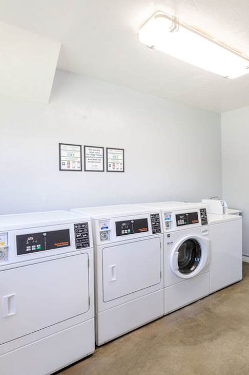 a laundry room with washing machines and a table