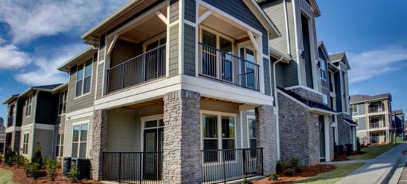 Beautiful blue and stone exterior featuring balconies at The Crest at Laurel Canyon, Canton, GA