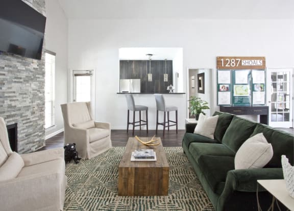 a living room with a green couch and a coffee table