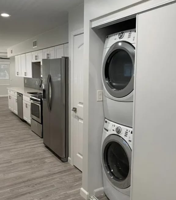 A row of washing machines in a laundry room.