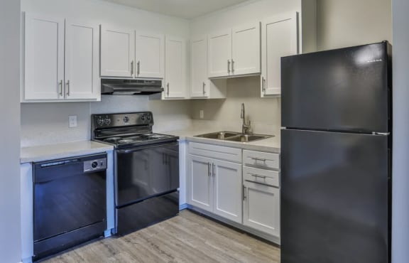 a kitchen with stainless steel appliances and white cabinets at Ashbrook Village, Gastonia, North Carolina