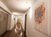 Thumbnail 7 of 10 - A hallway with a large painting on the wall. at The Mobile Lofts, Alabama, 36604