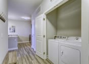 Thumbnail 7 of 8 - a laundry room with a washer and dryer and a sink