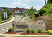Thumbnail 1 of 8 - the sign for weststone flats in front of a road and houses