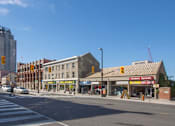 Thumbnail 4 of 8 - A street view of a city with a crosswalk and traffic lights.