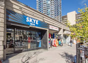 Thumbnail 1 of 8 - A storefront with the name SKYE WEAR on the awning.