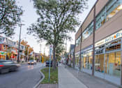Thumbnail 5 of 6 - A street view with a tree, a car and a building with a sign that says "Beltry".
