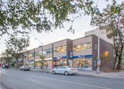 Thumbnail 1 of 6 - A car is parked in front of a 7-Eleven store.
