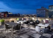 Thumbnail 11 of 35 - Tables chairs on rooftop at The Citizens Apartments