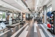 a spacious fitness center with treadmills and other exercise equipment