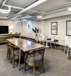 a conference room with a table and chairs and a tv