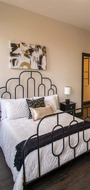 a bedroom with a bed and a green chair