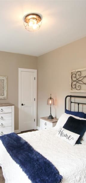 a bedroom with a bed and a dresser