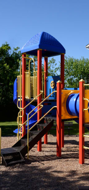 a playground in front of a school building