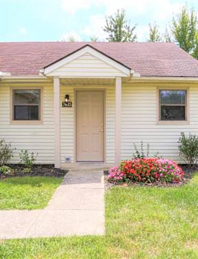 A house with a red door and a white garage door.