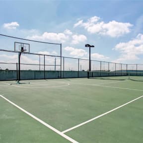 a tennis court on a sunny day with a blue sky