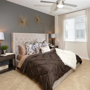 a bedroom with a bed and a ceiling fan