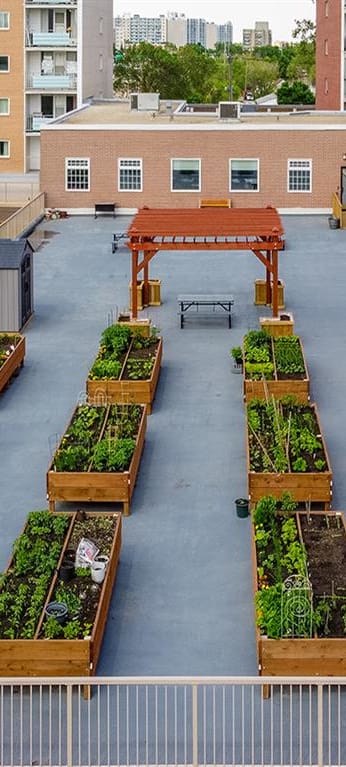 a courtyard filled with lots of wooden boxes filled with plants