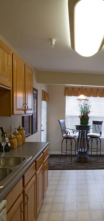 a kitchen with a stove and a sink and a refrigerator at The Summit at Owings Mills Apartments, Owings Mills, MD 21117