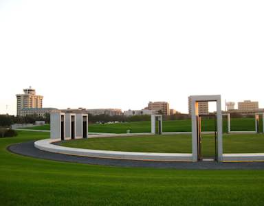 A monument with a curved walkway in front of it.
