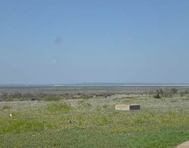 A field with a small building in the distance.