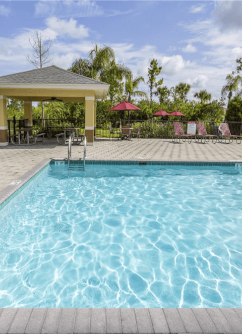 a bedroom with a bed and a painting of a bull at Heron Pond 55+ Apartments, Lehigh Acres, FL, 33972