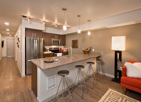 Kitchen island and living area at Infinity Apartments in Seattle WA