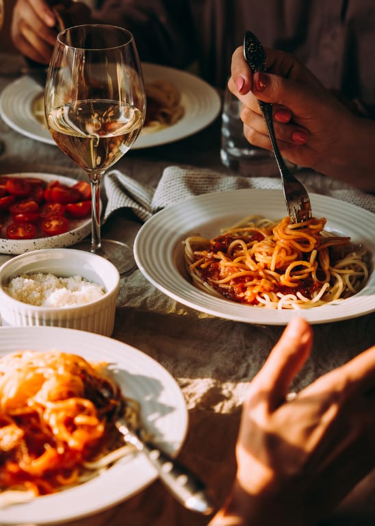 A group of people enjoying a meal together at a table.