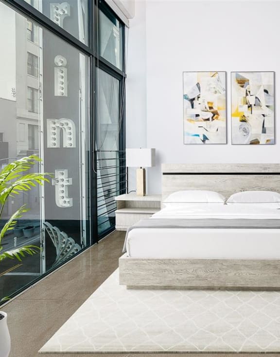 a bedroom with a bed and a window