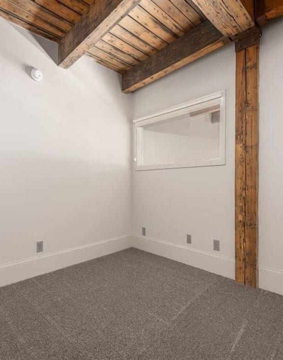 an empty room with white walls and a window at East 4th Street, Cleveland