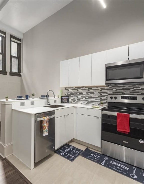a kitchen with an island and a stove and a microwave at East 4th Street, Cleveland
