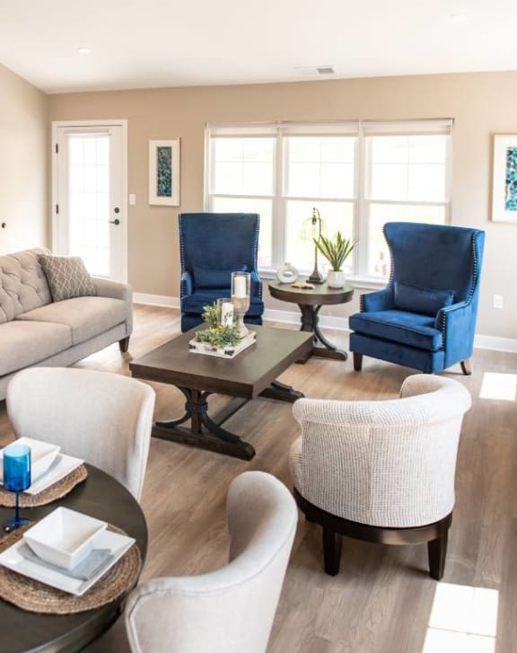 Champion Reserve Townhomes Interior view of Great Room showing dining area, living area, coffee bar, doorway to primary bedroom & door to private patio