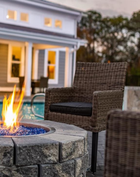 a fire pit in the middle of a patio with chairs at Westport Apartments, VA 23505