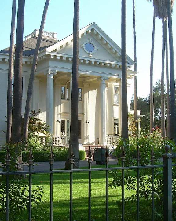 A white building with a blue sky in the background.