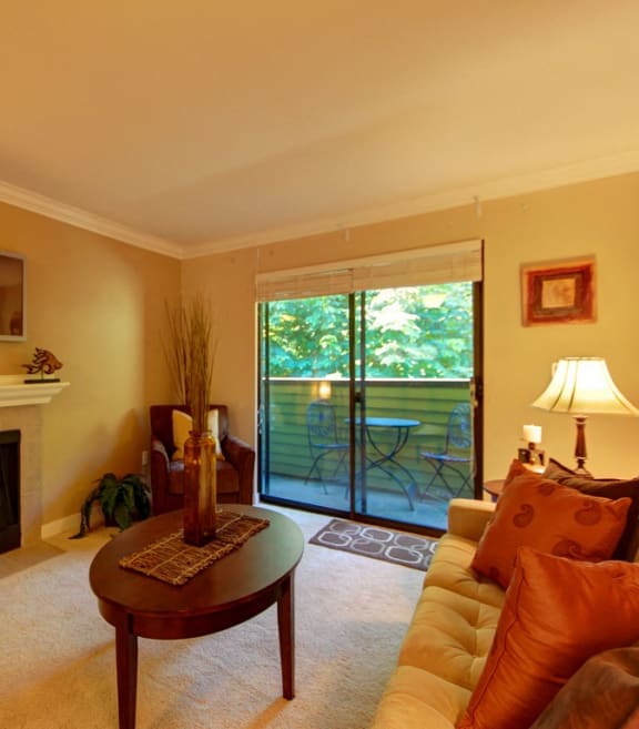 a living room with a fireplace and a sliding glass door