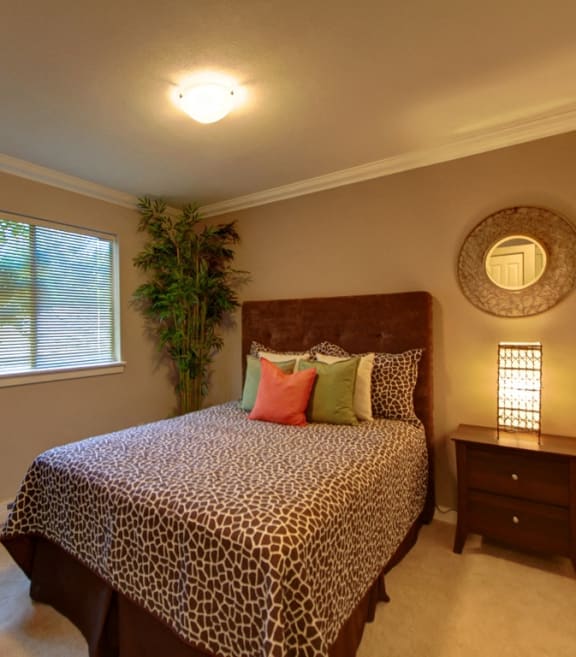 a bedroom with a bed and a potted plant
