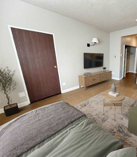 A bedroom with a bed, nightstand, and a ceiling fan.at LSOP-Lakeside, LLC Apartments, Reno, NV